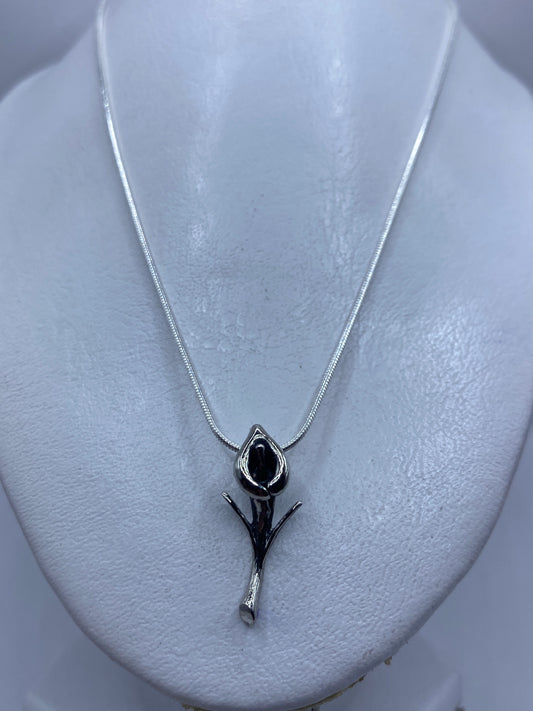 Dije floral de plata .925 de Taxco sobre cuello de maniquí, mostrando tamaño real