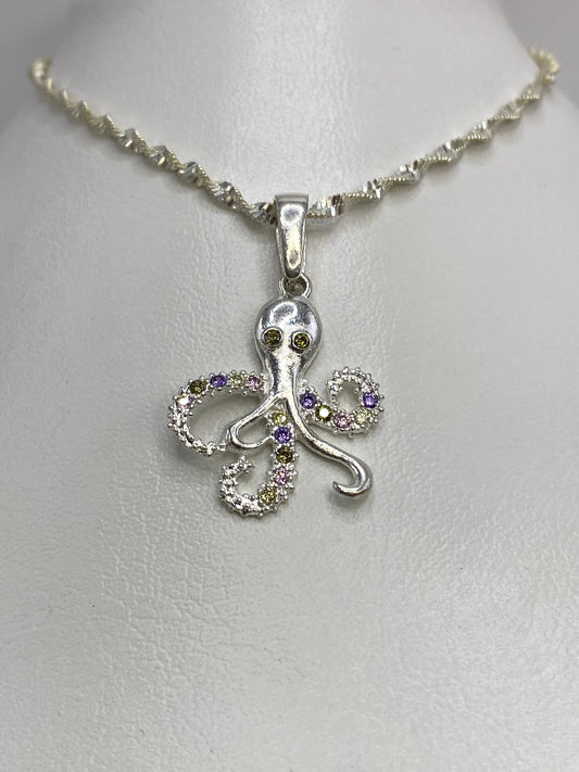 Detalle del pulpo de plata mostrando el patrón de micro-engaste en purpura, amarillo verdoso e incoloro