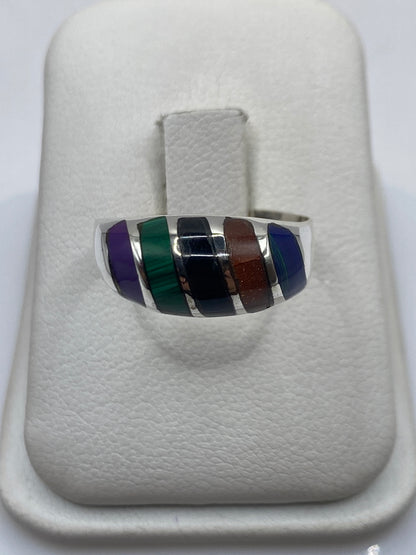 Anillo de plata .925 con piedra verde y negra sobre estuche blanco