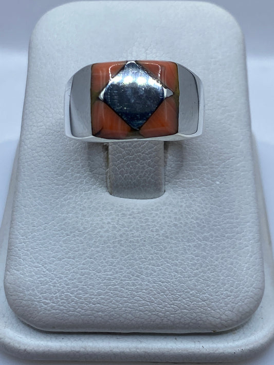 Anillo de plata .925 con piedra engastada a mano, vista frontal sobre joyero blanco