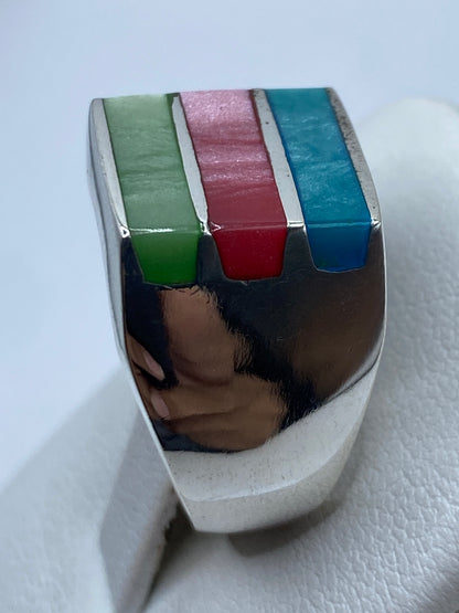 Anillo en mano mostrando el volumen geométrico y los colores de las piedras