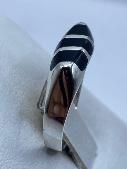 Detalle del anillo en mano, ónix negro brillante con plata pulida alrededor