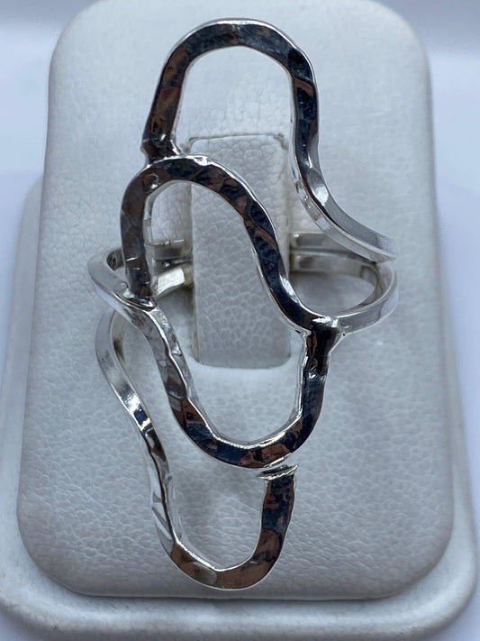 Anillo de plata repujada minimalista en la mano de una mujer