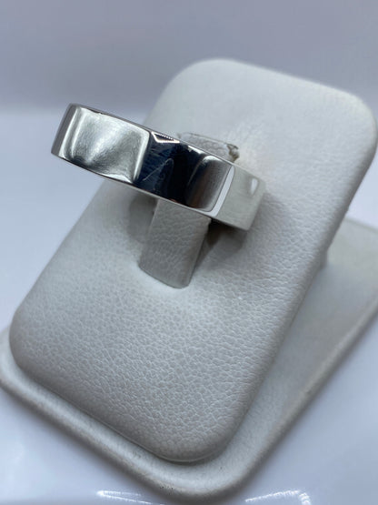 Anillo en la mano mostrando el volumen y el acabado pulido del cartoneado