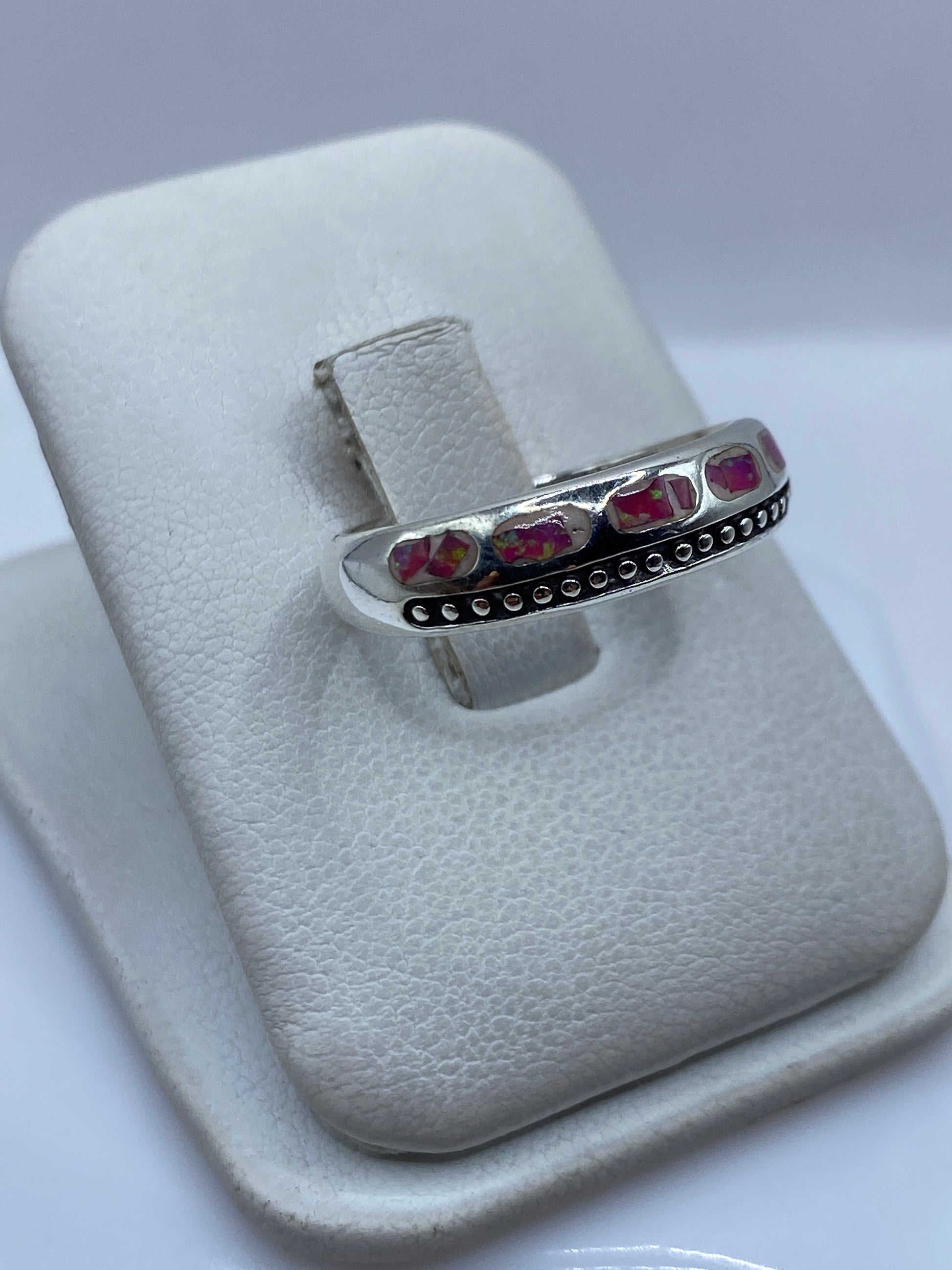 Detalle del engaste a mano del ópalo de fuego rosa en plata .950