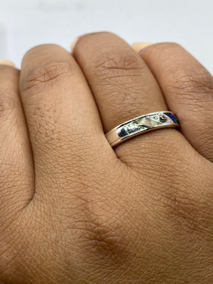 Anillo puesto en dedo mostrando el juego de colores del ópalo de fuego
