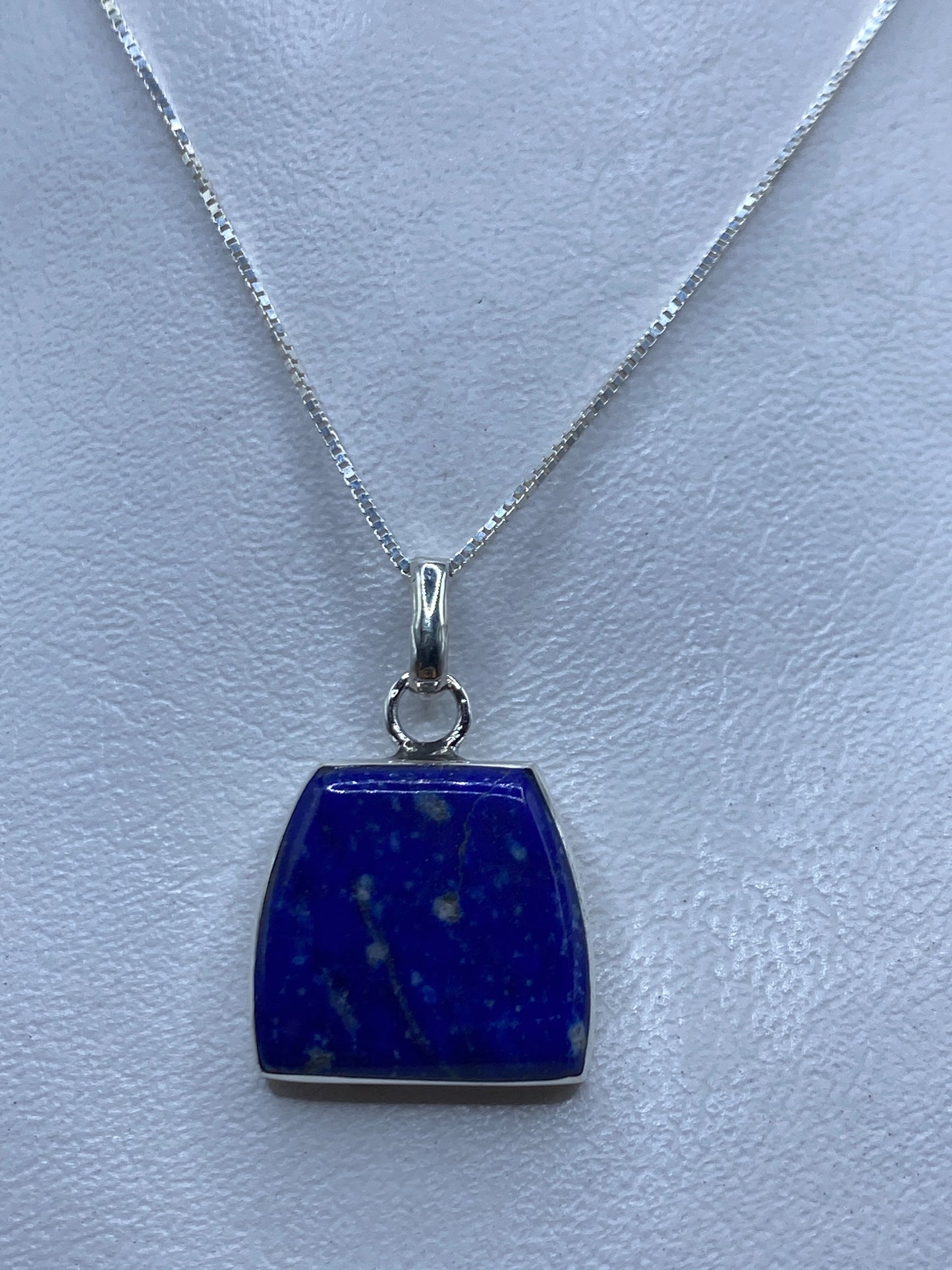 Dije de plata .950 engastado con piedra azul, colgado en cadena delgada de plata