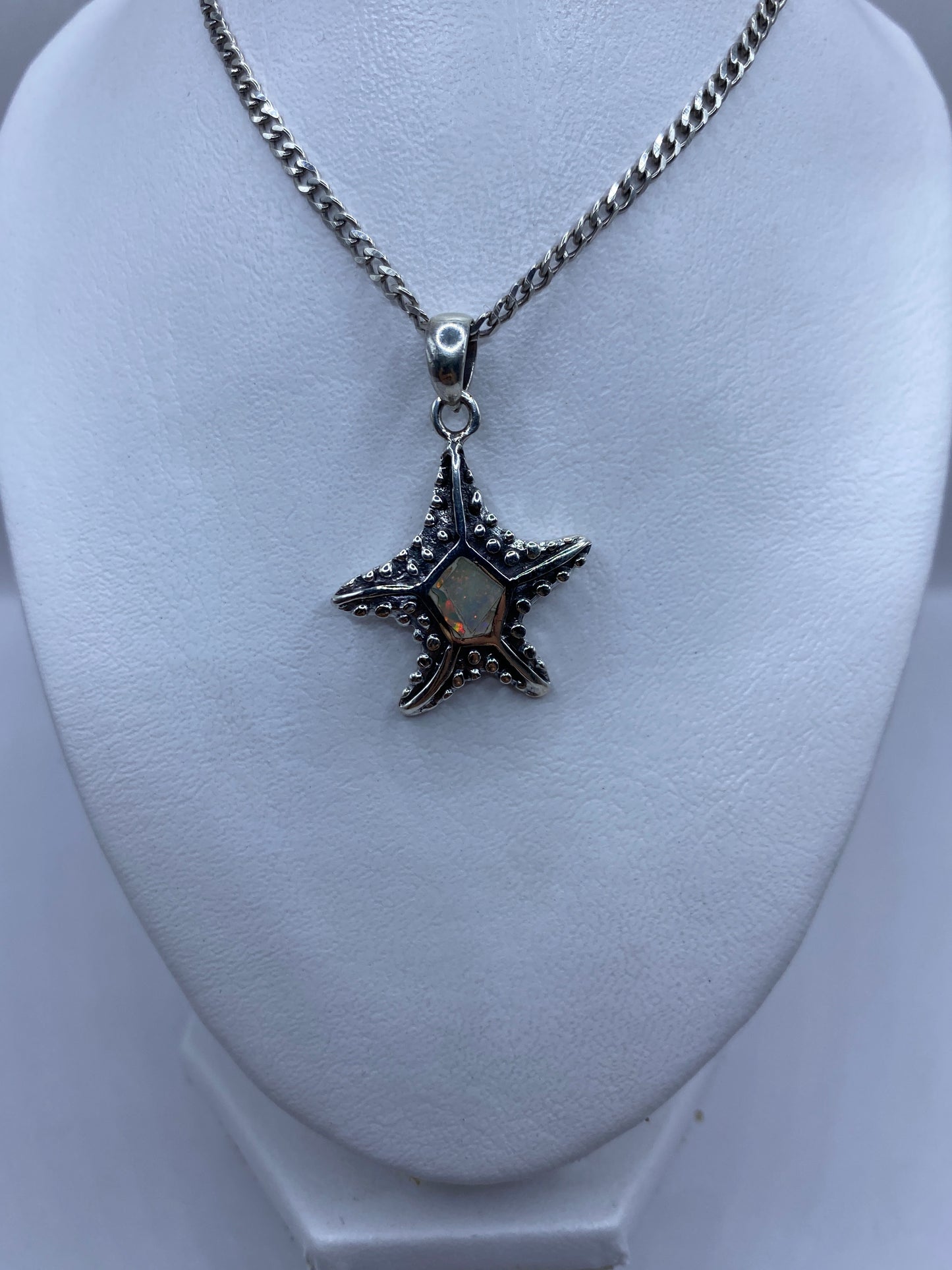 Detalle de la estrella marina de plata .950 con granulado artesanal y Ópalo de Fuego engastado