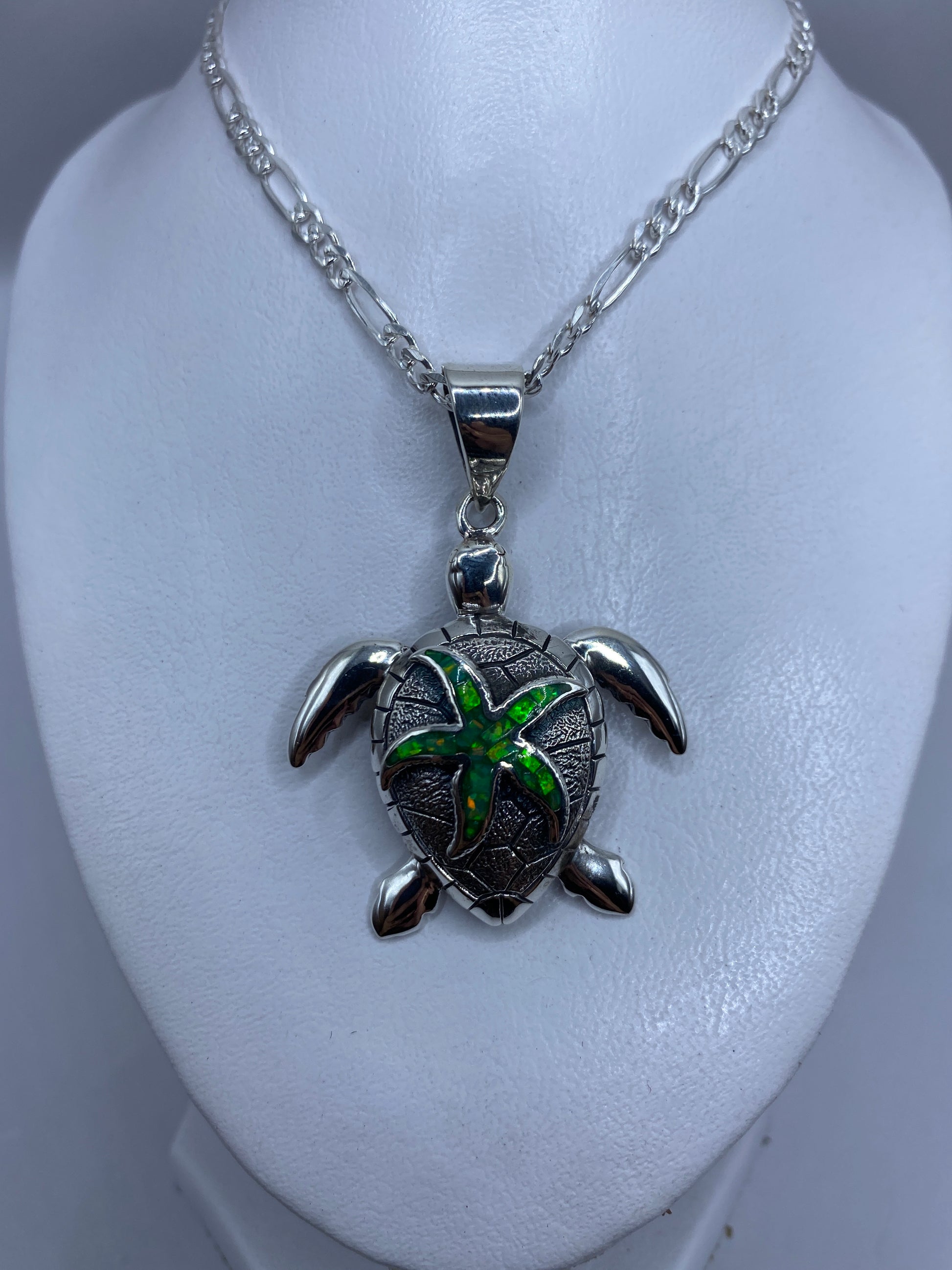 Detalle del ópalo de fuego verde y la textura de la tortuga marina en plata