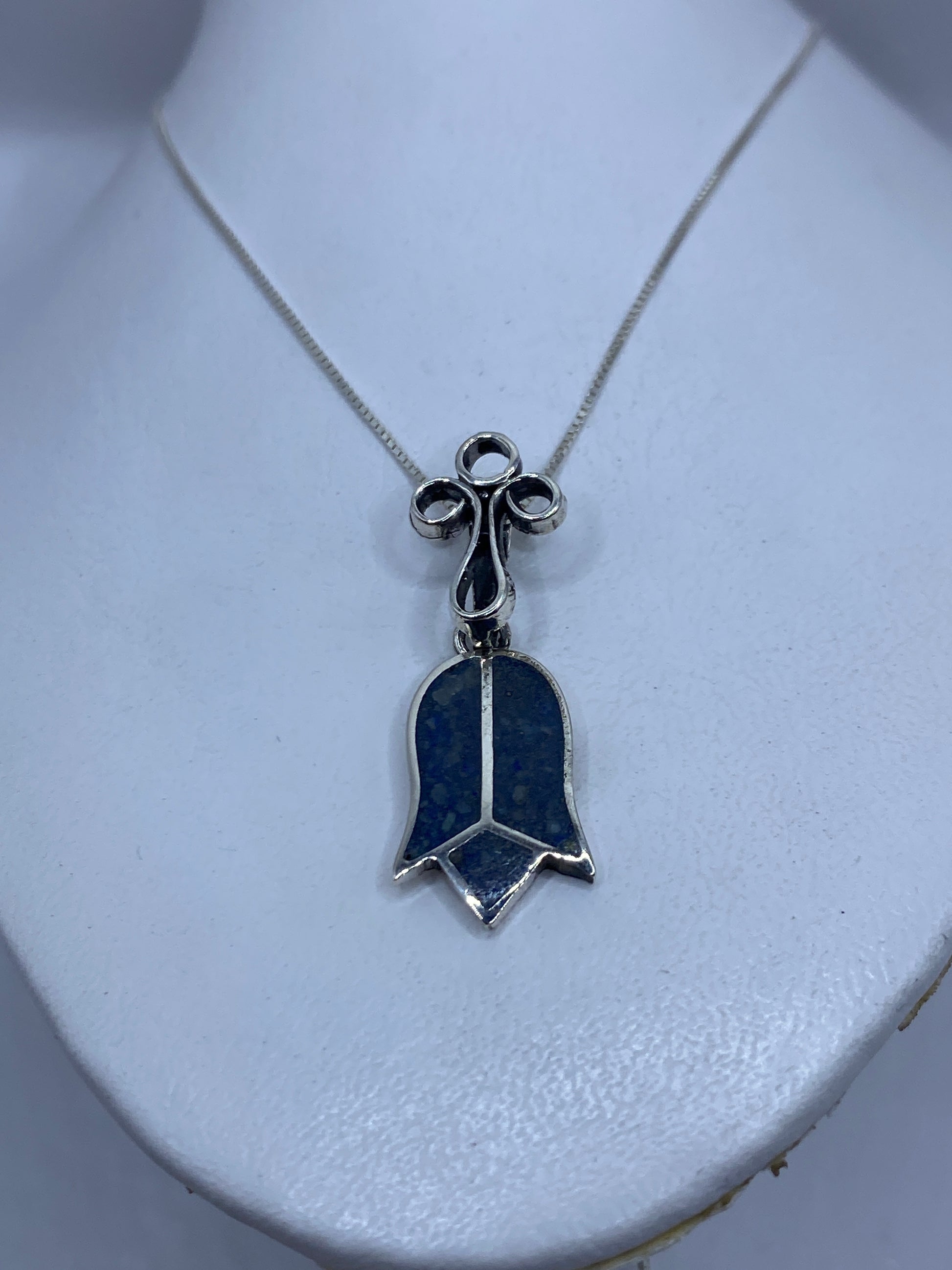 Detalle frontal de la campana con piedra azul y tres aros decorativos en plata
