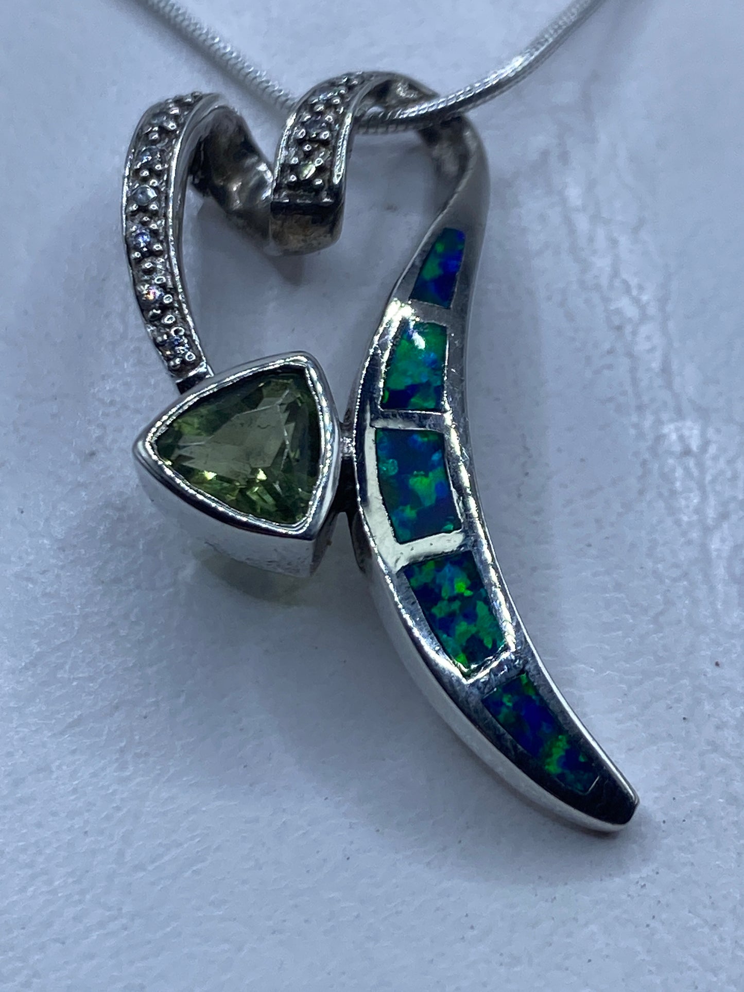 Dije de plata .925 con ópalo de fuego azul colgando de una cadena — vista frontal