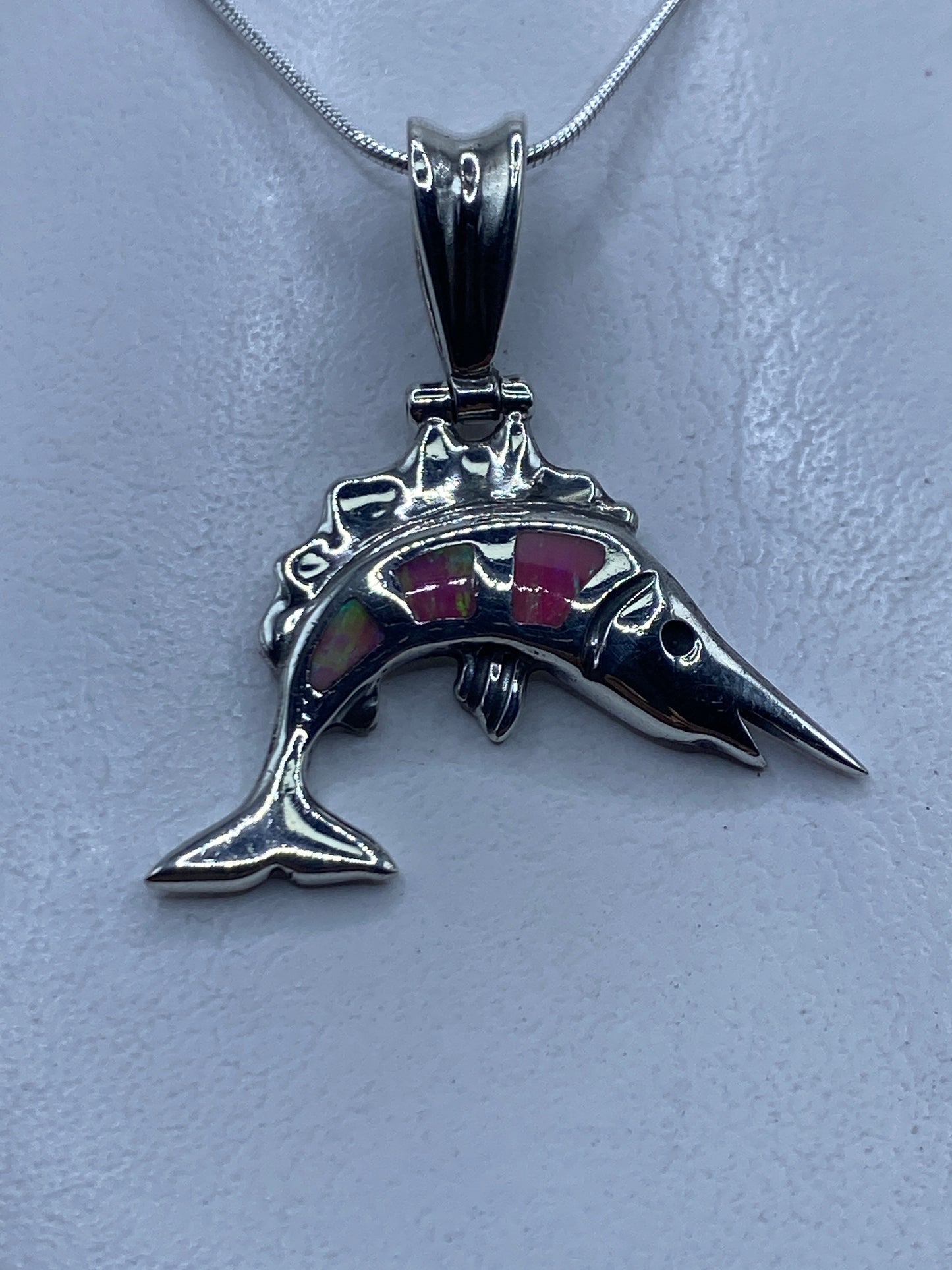 Dije delfín en plata .950 con ópalo de fuego rosa, visto de frente sobre cadena de plata