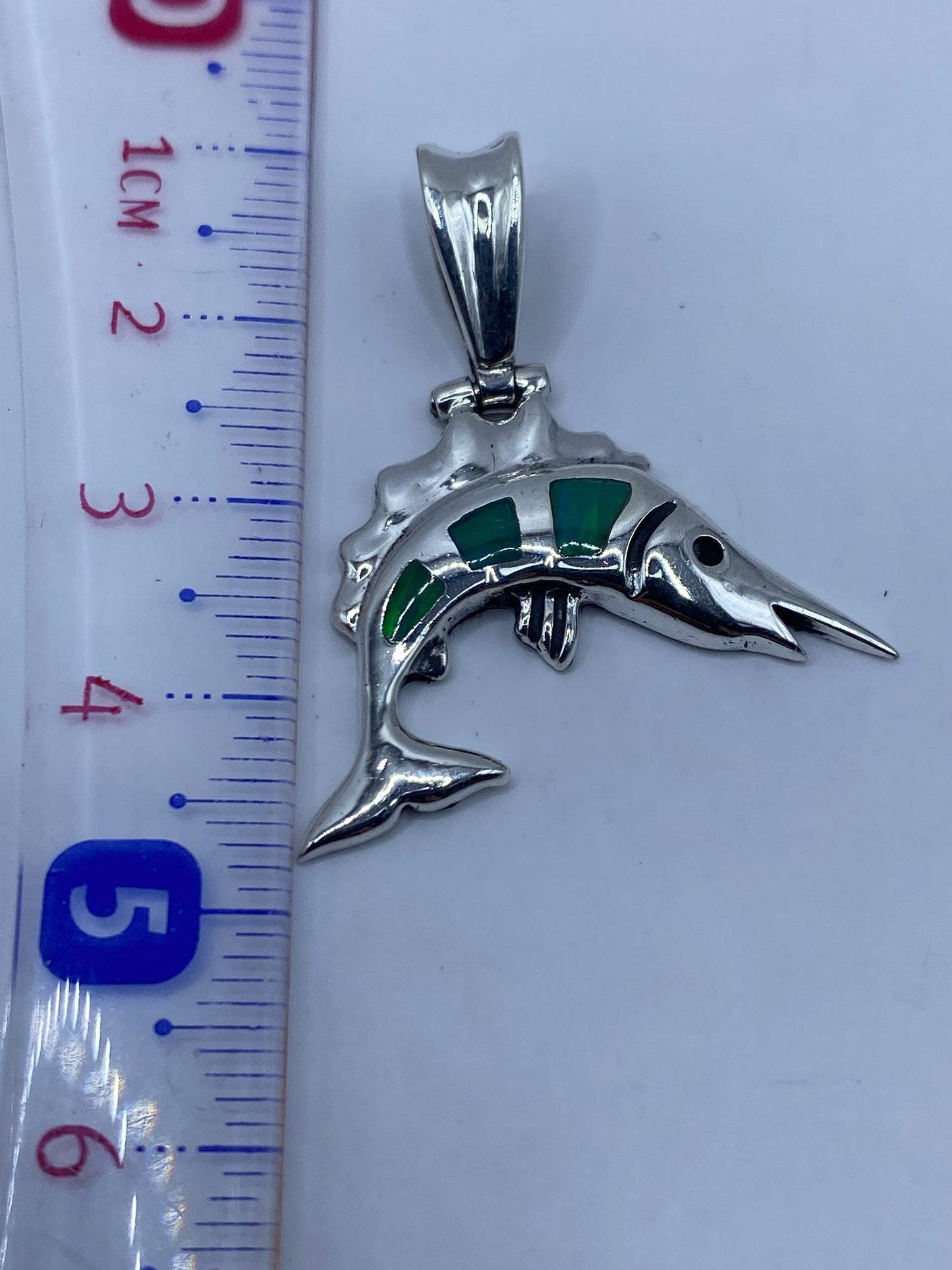 Medición del dije en escala: 4.2 cm de largo · Peso 4.8 gramos