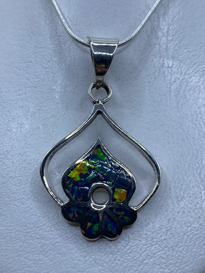 Dije de plata floral con ópalo de fuego natural, tonos verdes y azules, colgado en cadena