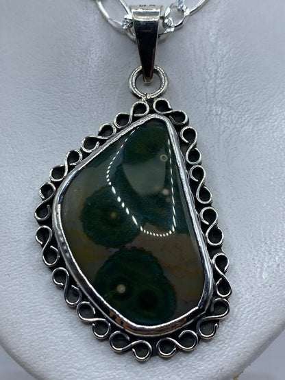 Dije pear de plata .925 con piedra verde olivo, engastada en marco de filigrana, sobre cadena de plata
