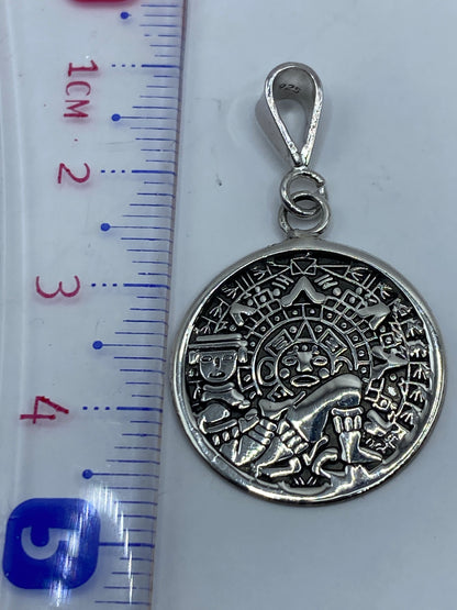 Dije de 4.5 cm de largo en escala junto a regla de medición