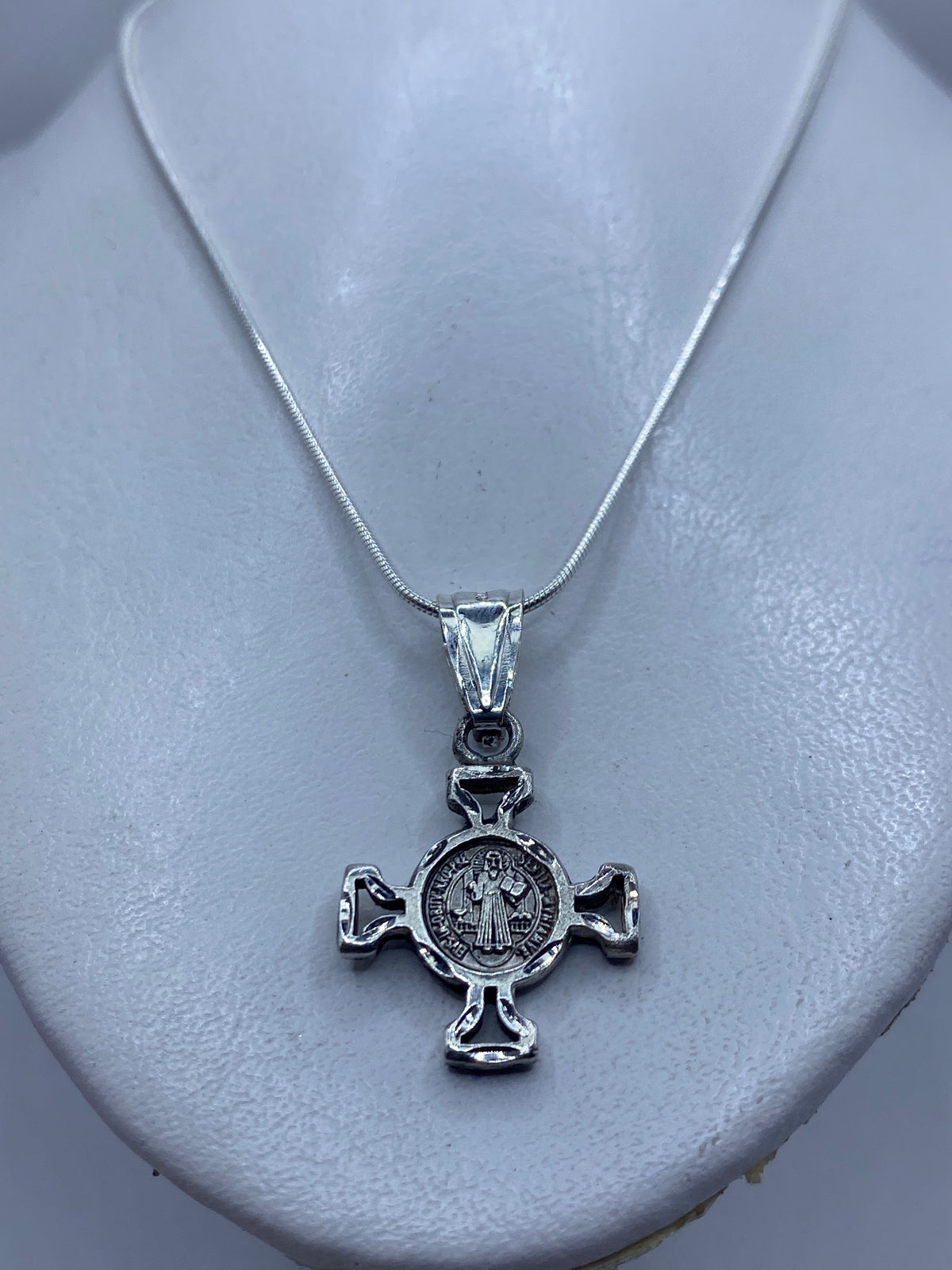 Detalle del medallón con la figura de San Benito y las inscripciones