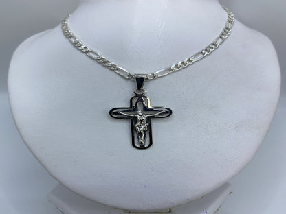 Crucifijo plateado colgando de cadena en el cuello de una persona