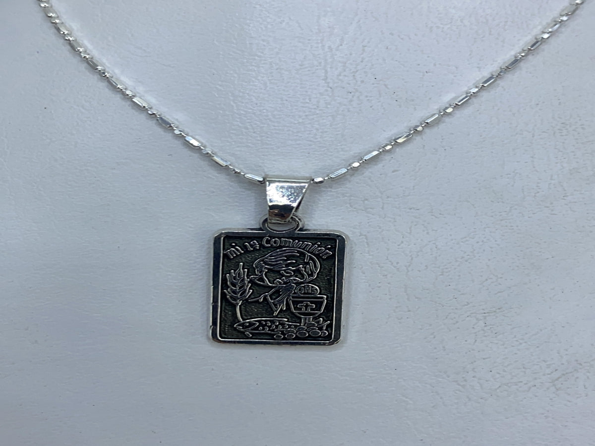 Detalle del diseño repujado del dije religioso de Taxco