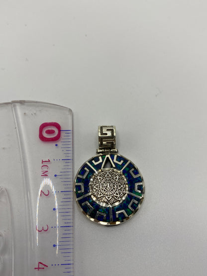 Reverso del dije mostrando el acabado pulido y el Quinto .950 grabado