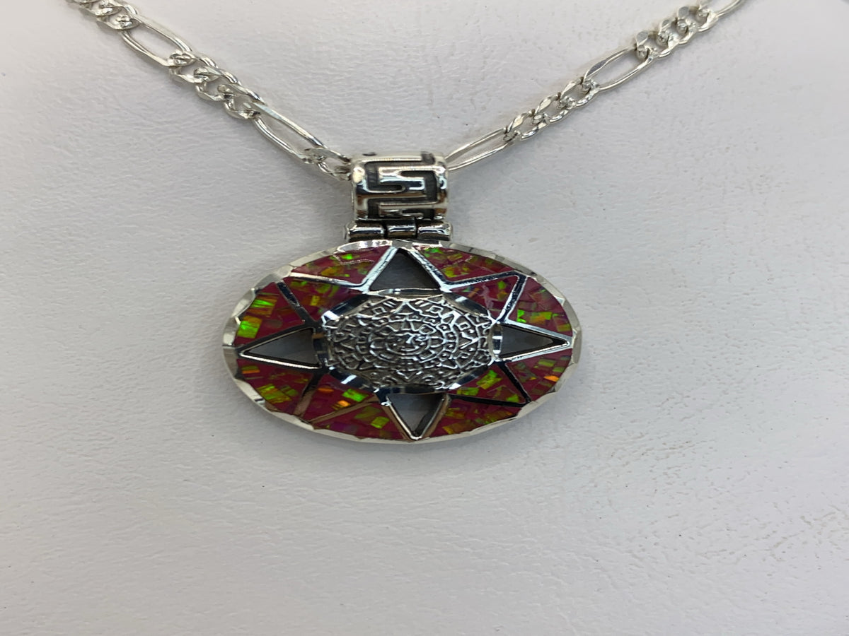Dije de plata con Ópalo de Fuego rosa y detalles geométricos negros en la mano