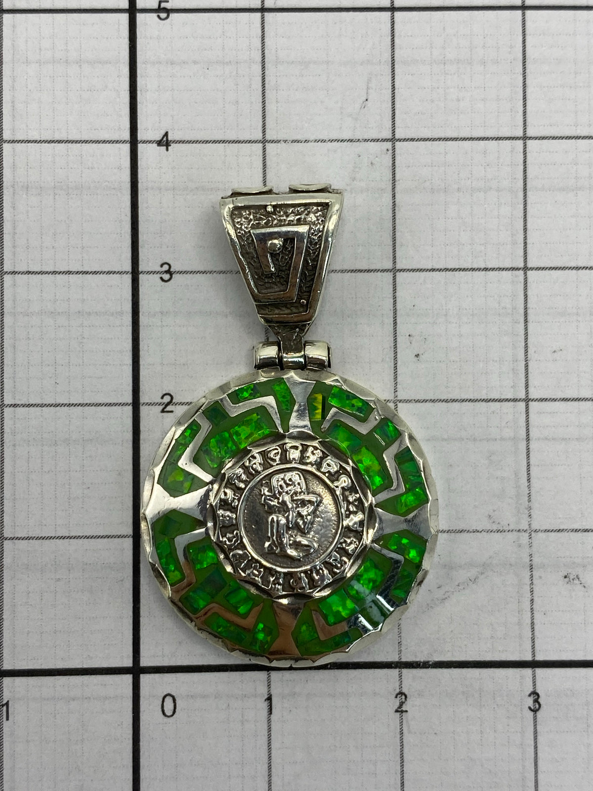 Dije sobre regla para escala — largo 3.5 cm, ancho 2.2 cm
