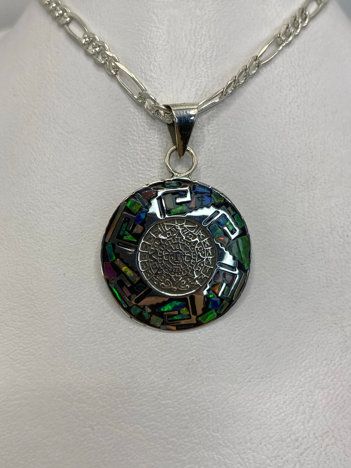 Detalle frontal del dije mostrando el ópalo de fuego y el engaste artesanal de plata