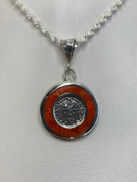 Dije de plata con rueda maya y ópalo de fuego naranja colgando de una cadena de plata