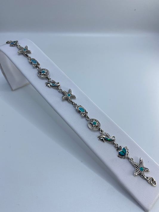Pulsera de plata 925 con ópal azul engastado, vista completa sobre fondo blanco