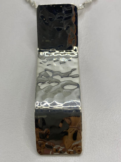 Reverso del dije de plata con Quinto 925 y marca MEXICO TAXCO