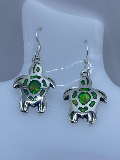 Par de aretes verde limon con detalles de plata en forma de tortuga marina