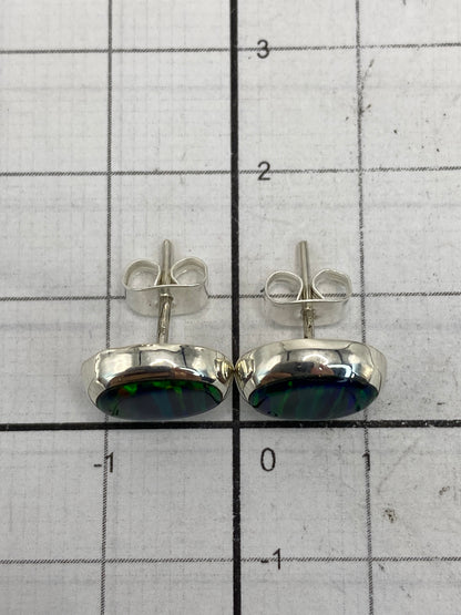 Reverso de los aretes mostrando el Quinto 925 y el cierre de mariposa