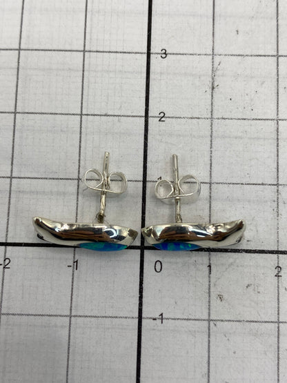 Aretes sobre escala de medición mostrando su tamaño compacto de 1.4 cm × 1.5 cm