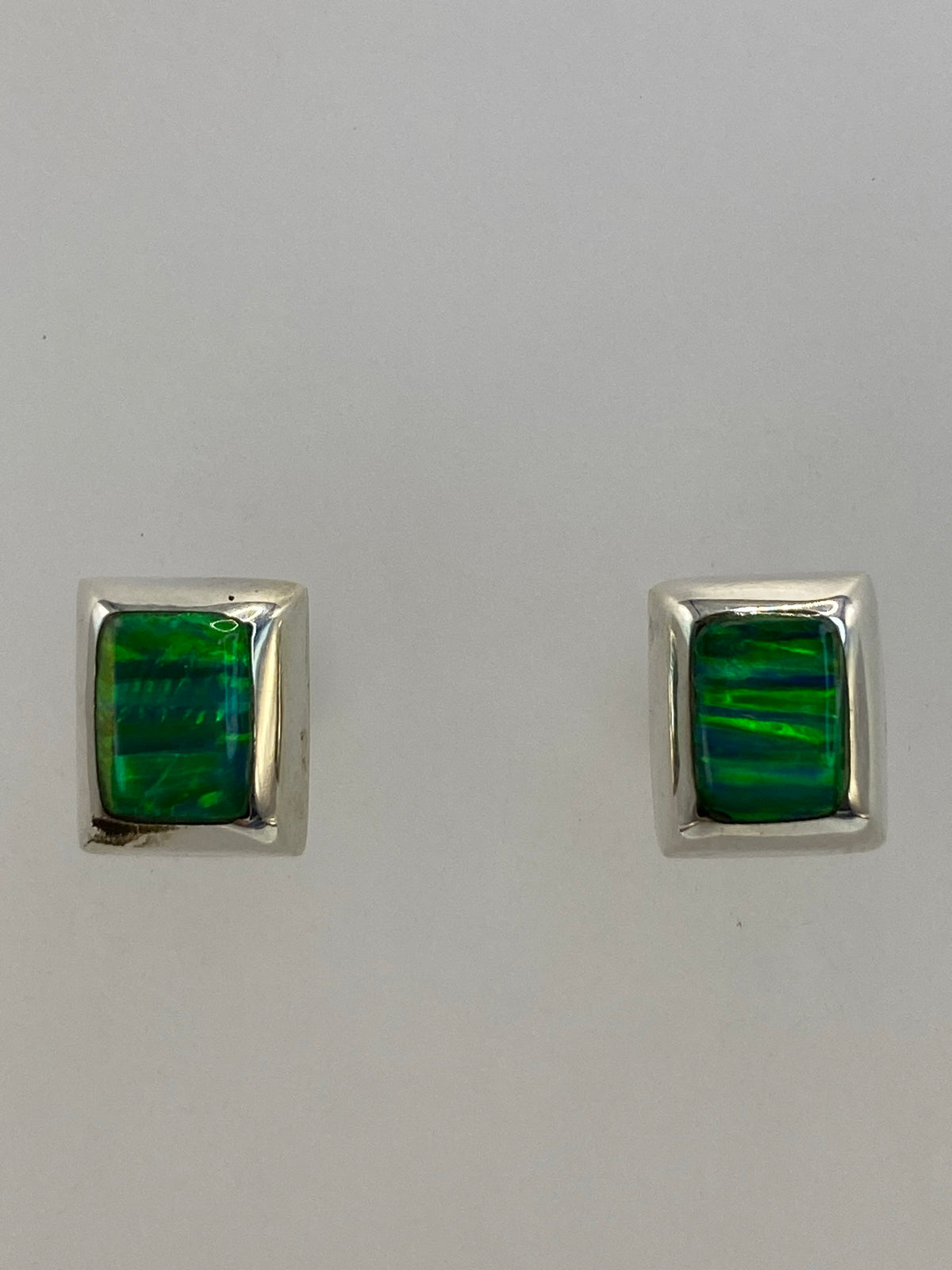 Par de aretes sobre escala mostrando 1.3 cm de largo y 1.1 g de peso total