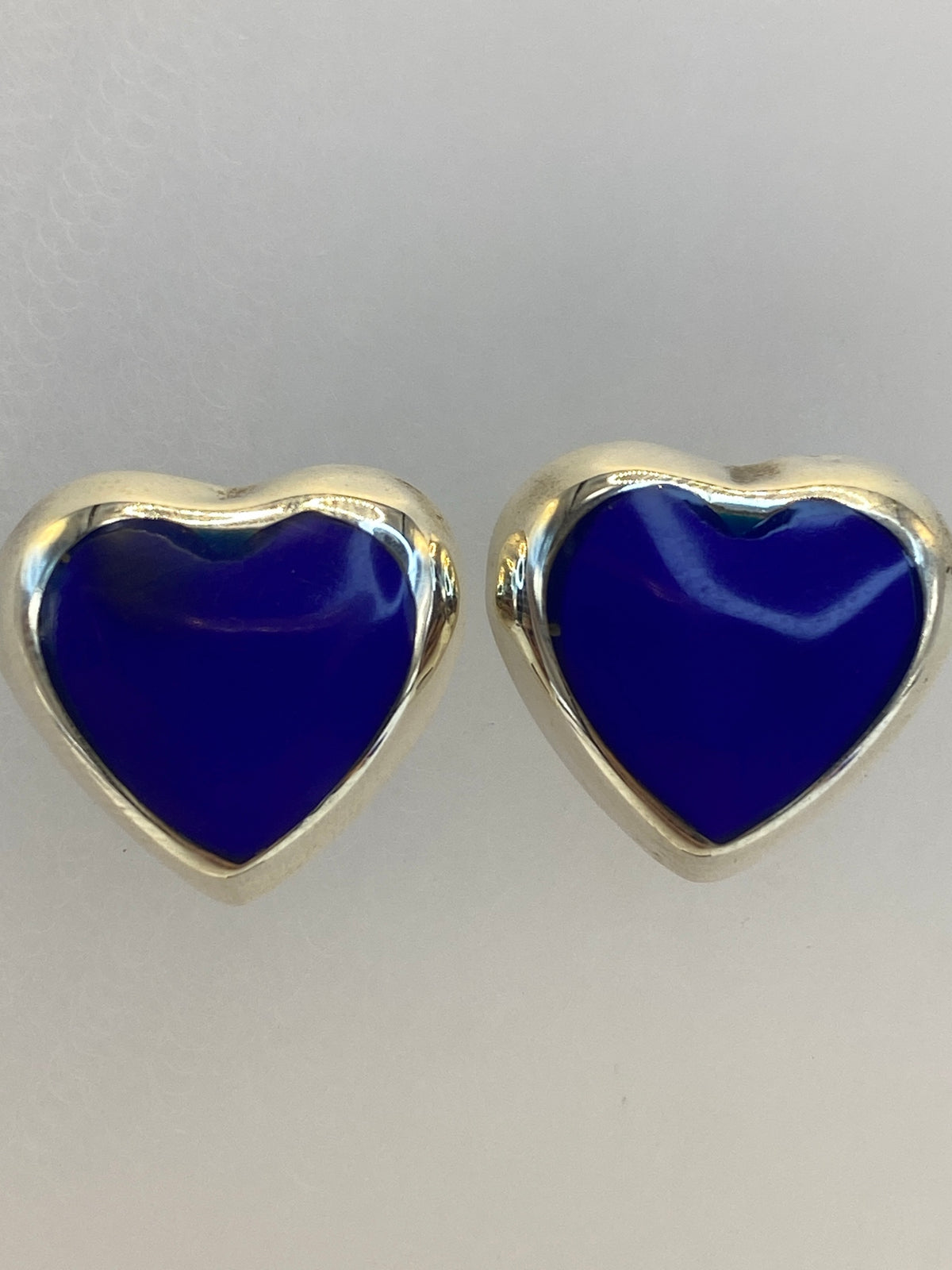 Aretes de plata corazón azul sobre regla de centímetros mostrando tamaño de 1.4 cm