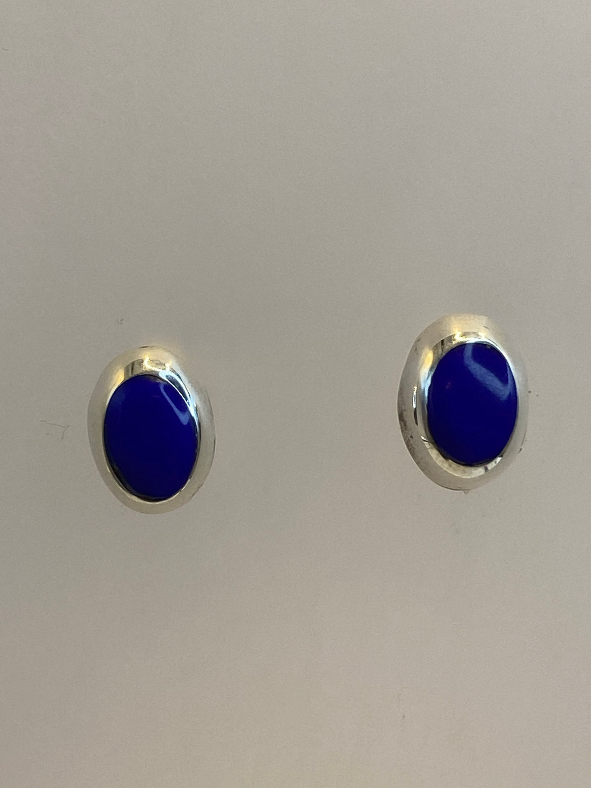 Par de aretes de plata 925 con piedra azul, vistos de frente