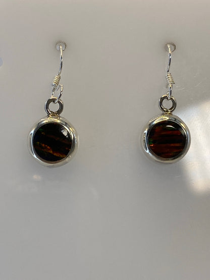Close-up of fire opal gemstone in silver 950 setting showing orange and red fire reflections