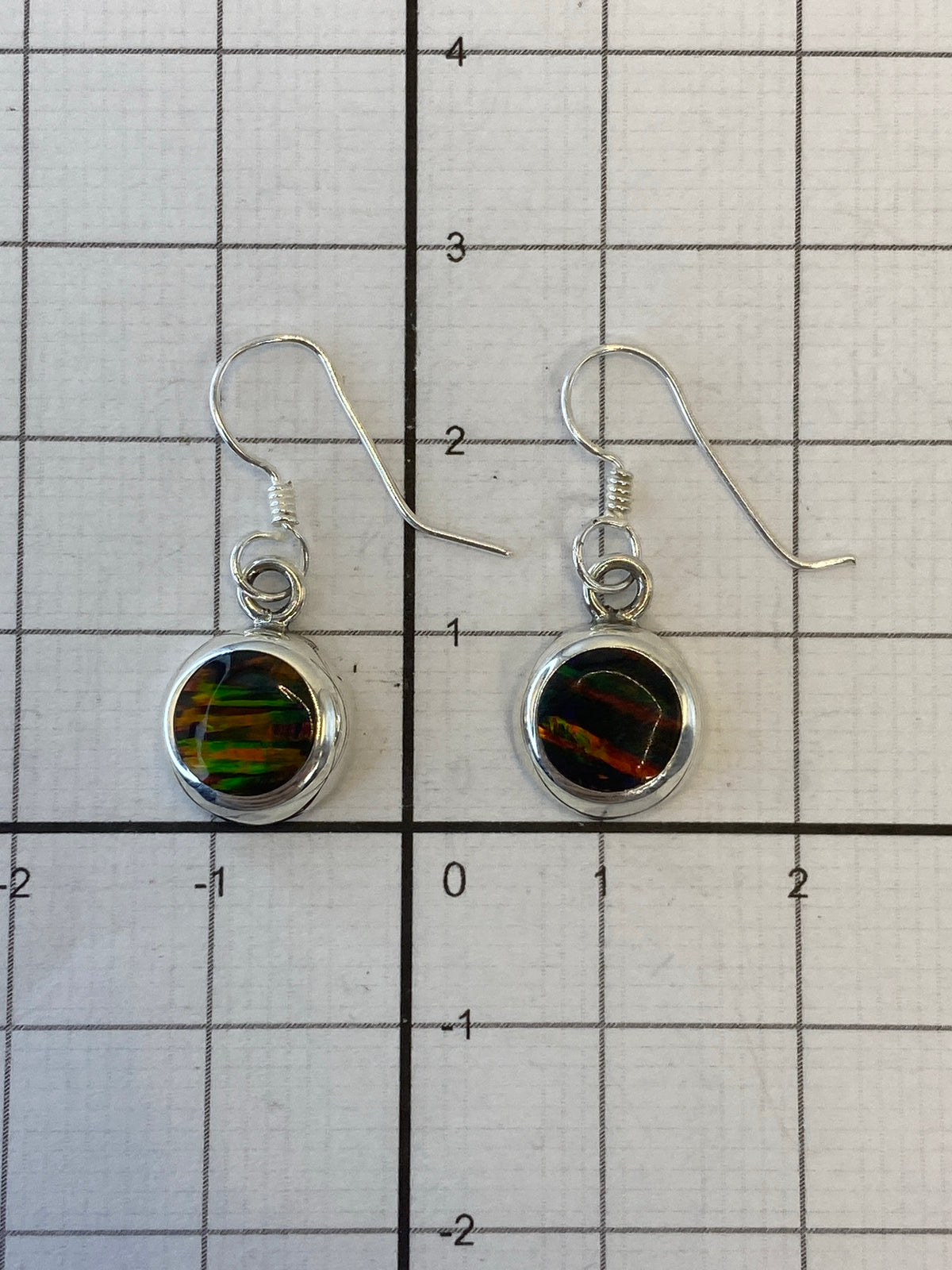 Back view of silver fire opal earrings showing hallmark 950 and hand-set stone detail