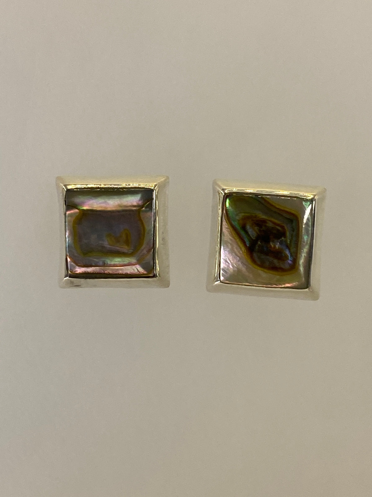 Par de aretes de plata 925 con incrustación de piedra multicolor sobre fondo blanco
