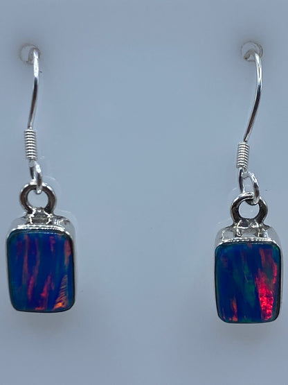 Aretes sobre regla mostrando largo de 2.6 cm