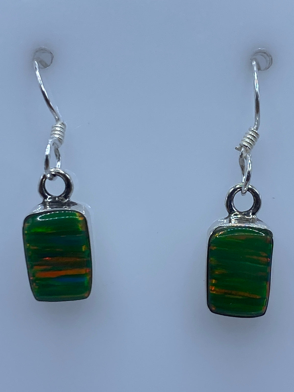 Par de aretes de plata 950 con opalo de fuego verde natural, colgando de gancho plateado