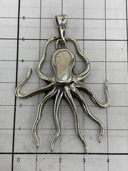 Dije pulpo sobre escala de centímetros, midiendo 6.2 cm de largo con Quinto 925 visible