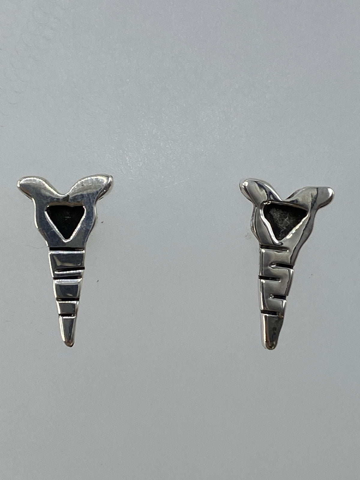 Aretes de plata colgando, vista lateral del diseño geométrico