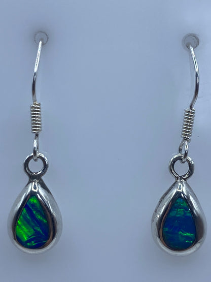 Aretes de plata 925 con Quinto, sobre fondo gris
