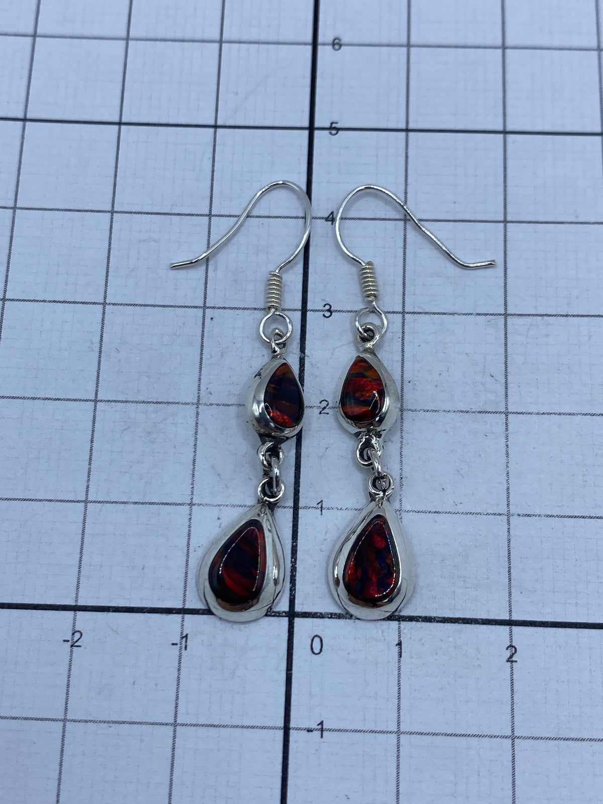 Aretes sobre fondo claro con marca del Quinto 925 visible en el gancho