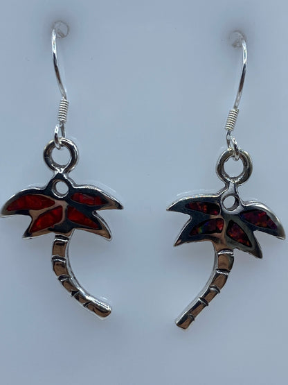 Aretes de palmera sobre escala de medición mostrando largo de 3.7 cm