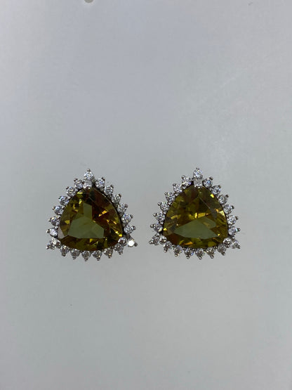 Detalle frontal de un arete mostrando la circonia verde olivo engastada en la corona de plata