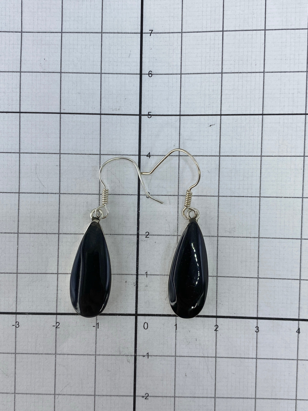 Aretes colgando en la oreja, mostrando caída elegante de 4 cm