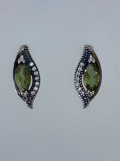 Par de aretes de plata con circonia verde olivo sobre fondo blanco