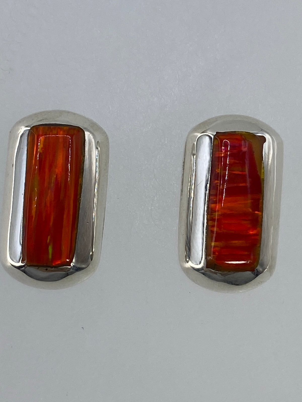 Aretes de Ópalo de Fuego en plata — detalle del engaste y brillo de la piedra